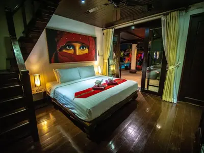 a bedroom with a bed with a painting on the wall at Luxury 8 - 9 Bedroom Villa With 2 Pools in Kamala Beach