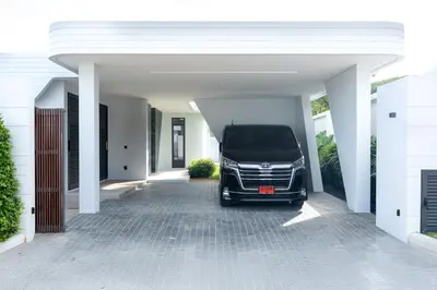 a car is parked under a white garage at Zavaya Luxury Private Pool Villa Phuket in Layan Beach