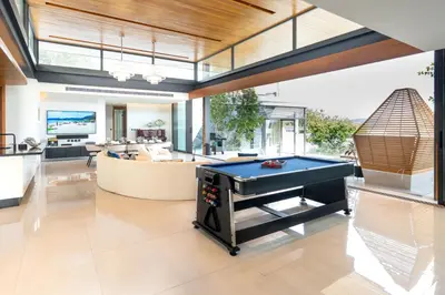 a living room with a pool table in it at Zavaya Luxury Private Pool Villa Phuket in Layan Beach