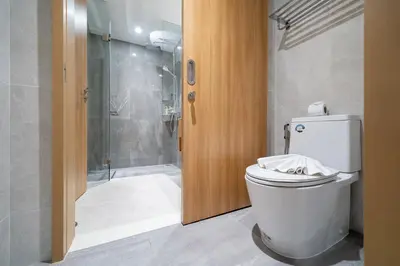 a bathroom with a toilet and a shower at Laguna Beachside Apartment 300 meters to the Bangtao Beach in Bang Tao Beach