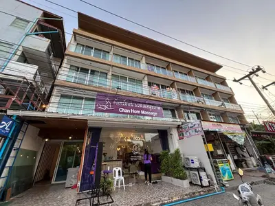 a woman standing in front of a building at Aqua Inn Ao Nang in Ao Nang Beach