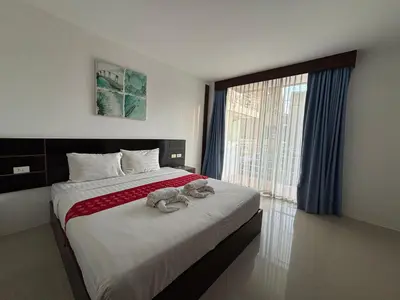 a bedroom with a bed with stuffed animals on it at Aqua Inn Ao Nang in Ao Nang Beach