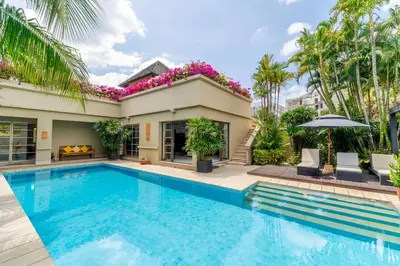 a swimming pool in front of a villa at Exotic 3BR Villa Solandra with Tropical Pool and Private Rooftop Terrace in Bangtao in Bang Tao Beach