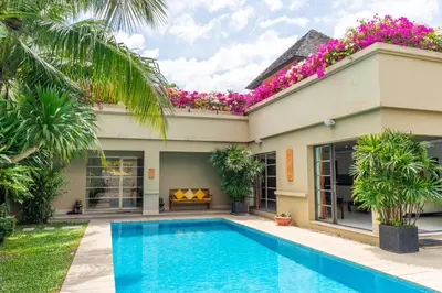 a villa with a swimming pool in front of a house at Exotic 3BR Villa Solandra with Tropical Pool and Private Rooftop Terrace in Bangtao in Bang Tao Beach