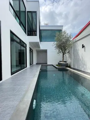 an external view of a house with a swimming pool at Modern ZEN Vibe 3BR Pool Villa Phuket in Ban Tha Khreng