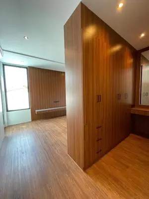a large wooden cabinet in a room with wood floors at Modern ZEN Vibe 3BR Pool Villa Phuket in Ban Tha Khreng