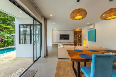 a living room with a table and a couch at V212 One Of The Most Beautiful Villa In Phuket in Bang Tao Beach
