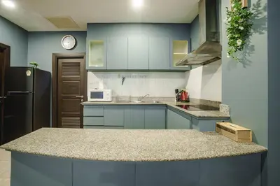 a kitchen with blue cabinets and a black refrigerator at Karon View 2 Bed 5 Minutes walk to Karon Beach 11 in Karon Beach