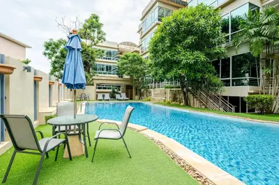 a table and chairs and an umbrella next to a swimming pool at Karon View 2 Bed 5 Minutes walk to Karon Beach 13 in Karon Beach