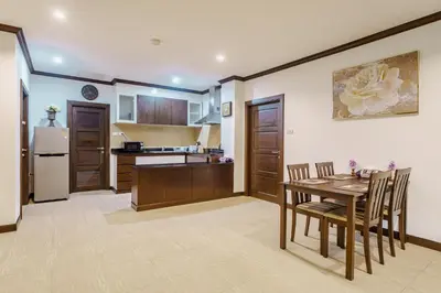 a kitchen with a table and chairs and a refrigerator at Karon View 2 Bed 5 Minutes walk to Karon Beach 13 in Karon Beach