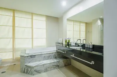 a bathroom with a bath tub and a sink at Karon View 2 Bed 5 Minutes walk to Karon Beach 13 in Karon Beach