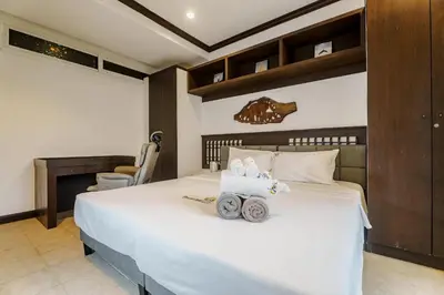 a bedroom with a large white bed with wheels on it at Karon View 2 Bed 5 Minutes walk to Karon Beach 13 in Karon Beach