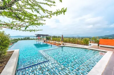 a swimming pool with a view of a mountain at C209 Surin Beachside Sun Escape & Infinity Pool in Surin Beach