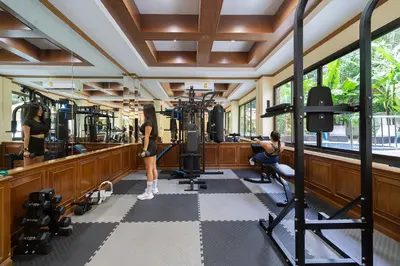a gym with two women working out in the gym at Patong Central Budget Stay in Patong Beach