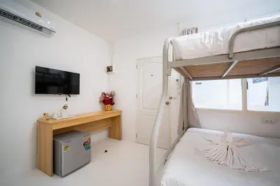 a bedroom with a bunk bed and a tv at ZJ House Phuket Town in Phuket Town