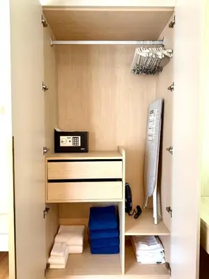 a walk in closet with a shelf and towels at Brand new apartment on Kamala in Kamala Beach