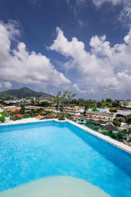 a large swimming pool with a view of a city at Brand new apartment on Kamala in Kamala Beach