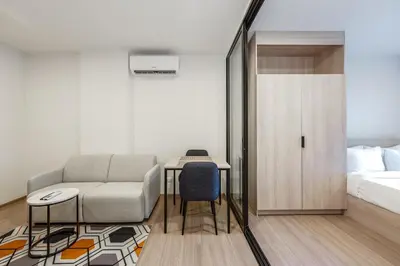 a living room with a couch and a bed at C213 Fit Chill Condo with Pool and Gym in Kathu