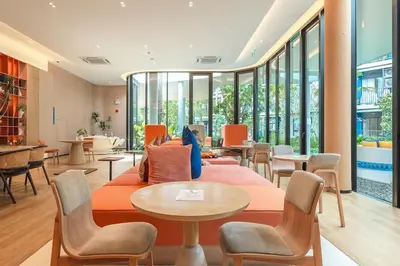 a lobby with a couch and tables and windows at C213 Fit Chill Condo with Pool and Gym in Kathu