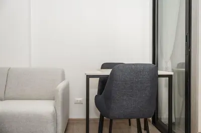 a chair and a desk with a chair and a chair at C213 Fit Chill Condo with Pool and Gym in Kathu
