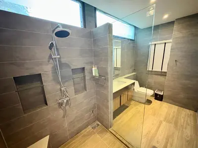 a bathroom with a shower and a sink and a toilet at Rawai House 16 in Ban Saiyuan (1)