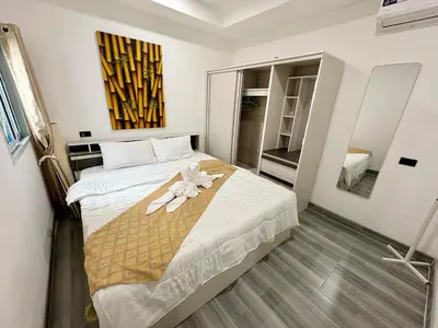 a bedroom with a bed with towels on it at Rawai House 16 in Ban Saiyuan (1)