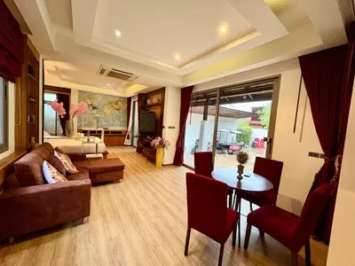 a living room with a couch and a table at Rawai House 16 in Ban Saiyuan (1)