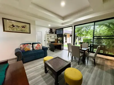 a living room with a couch and a table at Rawai House 16 in Ban Saiyuan (1)