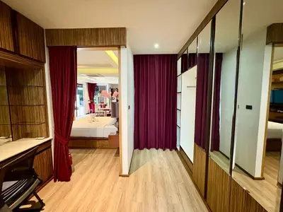 a bedroom with red curtains and a bed in a room at Rawai House 16 in Ban Saiyuan (1)