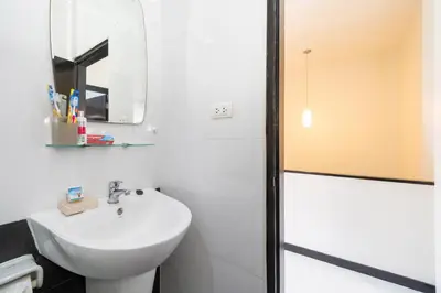 a white bathroom with a sink and a mirror at Laguna Townhouse with private pool, Bang Tao Beach in Laguna Phuket