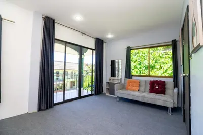 a living room with a couch and a large window at 3 Bed 3 Bath Villa 400m to Beach in Surin Beach