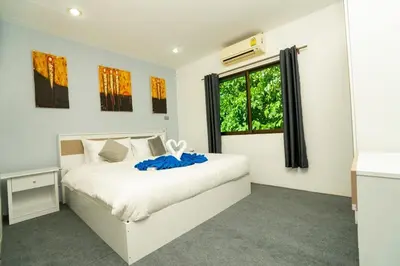 a bedroom with a white bed and a window at 3 Bed 3 Bath Villa 400m to Beach in Surin Beach