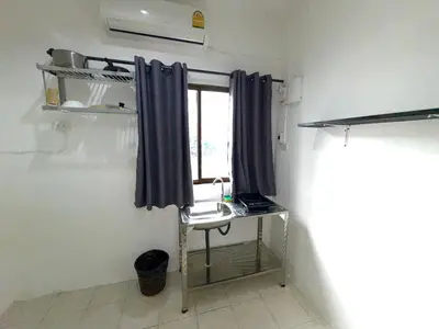 a small room with a table and a window at Patong Canal Villa 104 in Patong Beach