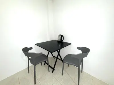 a black table and four chairs in a room at Patong Canal Villa 104 in Patong Beach