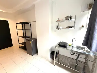 a small kitchen with a sink and a refrigerator at Patong Canal Villa 105 in Patong Beach