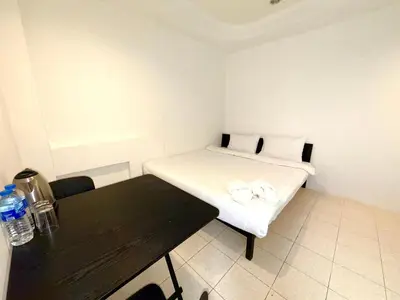 a small room with a table and a bed at Patong Canal Villa 105 in Patong Beach