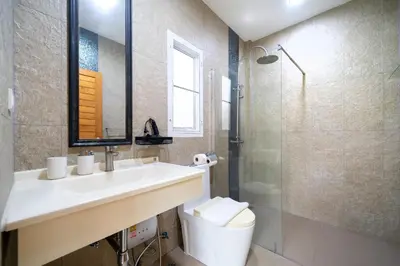 a bathroom with a sink and a toilet and a shower at Oxavia Garden Oasis B3 in Nai Harn with Jaccuzzi in Rawai Beach