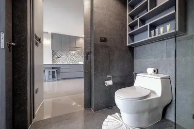 a bathroom with a toilet and a walk in shower at Tropics Kamala Apartment CTG L606, Several Pools, Gym & Rooftop in Kamala Beach