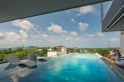 a swimming pool with a view of a building at Luxury 6BR Seaview Statement Villa - Villa Legend in Ban Saiyuan (1)