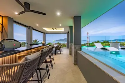a bar with chairs and a glass counter at Luxury 6BR Seaview Statement Villa - Villa Legend in Ban Saiyuan (1)