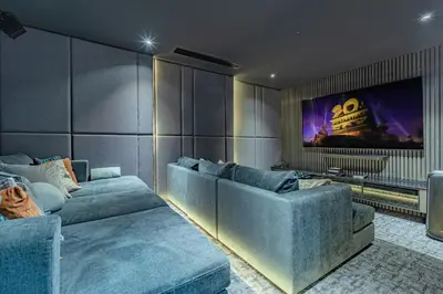 a living room with couches and a tv on a wall at Luxury 6BR Seaview Statement Villa - Villa Legend in Ban Saiyuan (1)