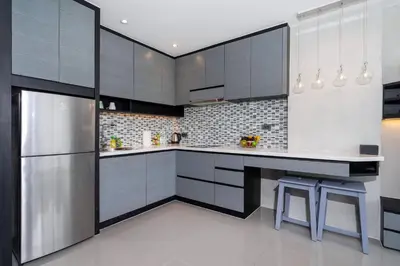 a kitchen with black and white cabinets and a counter at Scenic Hill View Apartment CTG P609 in Tropics Kamala residence, Great Facilities, Close to Beach and Fantasea in Kamala Beach