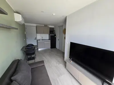 a living room with a couch and a flat screen tv at Modern Retreat 1- BedT3-529 in Chalong
