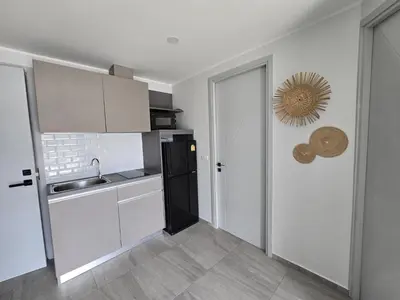 a kitchen with a sink and a black refrigerator at Modern Retreat 1- BedT3-529 in Chalong