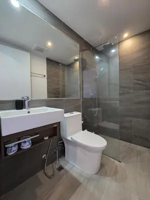 a bathroom with a toilet and a sink and a shower at Blue Edge Studio T3-527 in Chalong