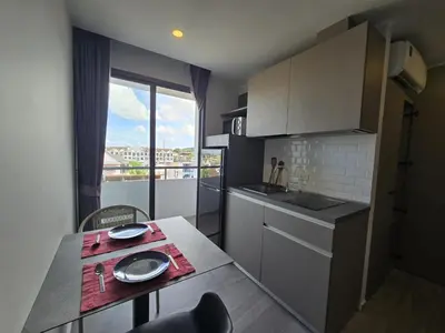 a small kitchen with a table and a window at Blue Edge Studio T3-527 in Chalong