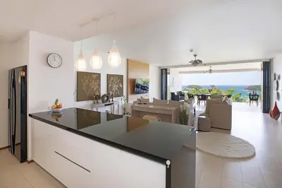 a kitchen and living room with a view of the ocean at Stunning Seaview Escape - Modern and Elegant in Kata Beach