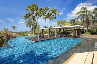 a swimming pool with palm trees and a gazebo at Stunning Seaview Escape - Modern and Elegant in Kata Beach
