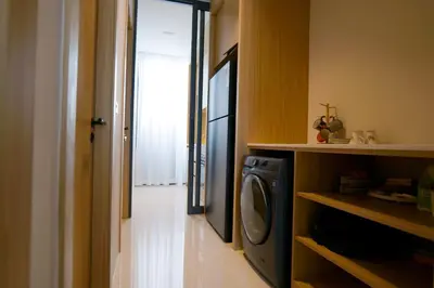 a laundry room with a washer and dryer next to a door at Relax Nai Yang beach pool Villas in Nai Yang Beach