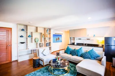 a living room with a couch and a table at Villa Talay in Surin Beach
